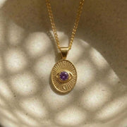 Divine Eye pendant detail showing the purple sapphire