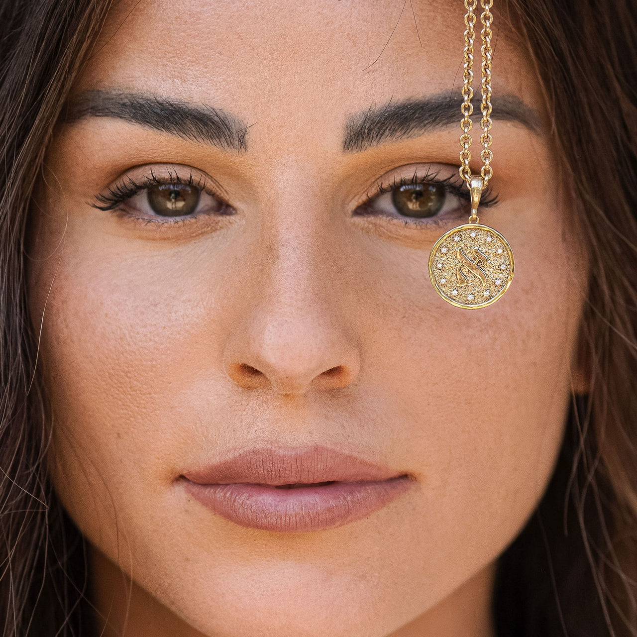 Letters of Light Alef pendant in 14k gold by Sages & Souls, worn