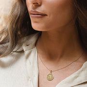 Letters of Light Hey pendant in 14k gold by Sages & Souls, worn