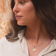 Letters of Light pendant layered with other necklaces