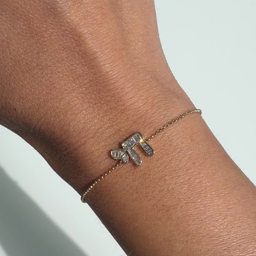 Hebrew Chai Baguette Diamond Bracelet worn on a wrist, showcasing the intricate design and elegance.