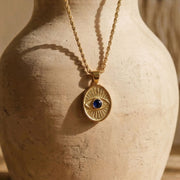 Protective Eye gold talisman with dark blue sapphire