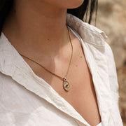 Model wearing the Protective Eye necklace in 14k gold