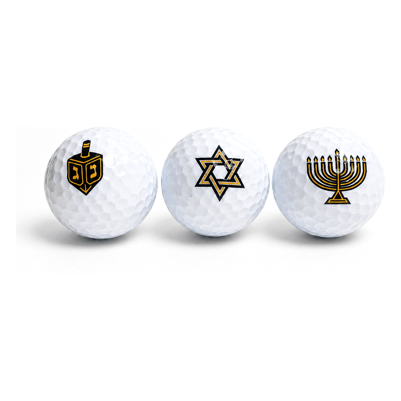 Three Hanukkah golf balls printed with a dreidel, a Star of David and a menorah