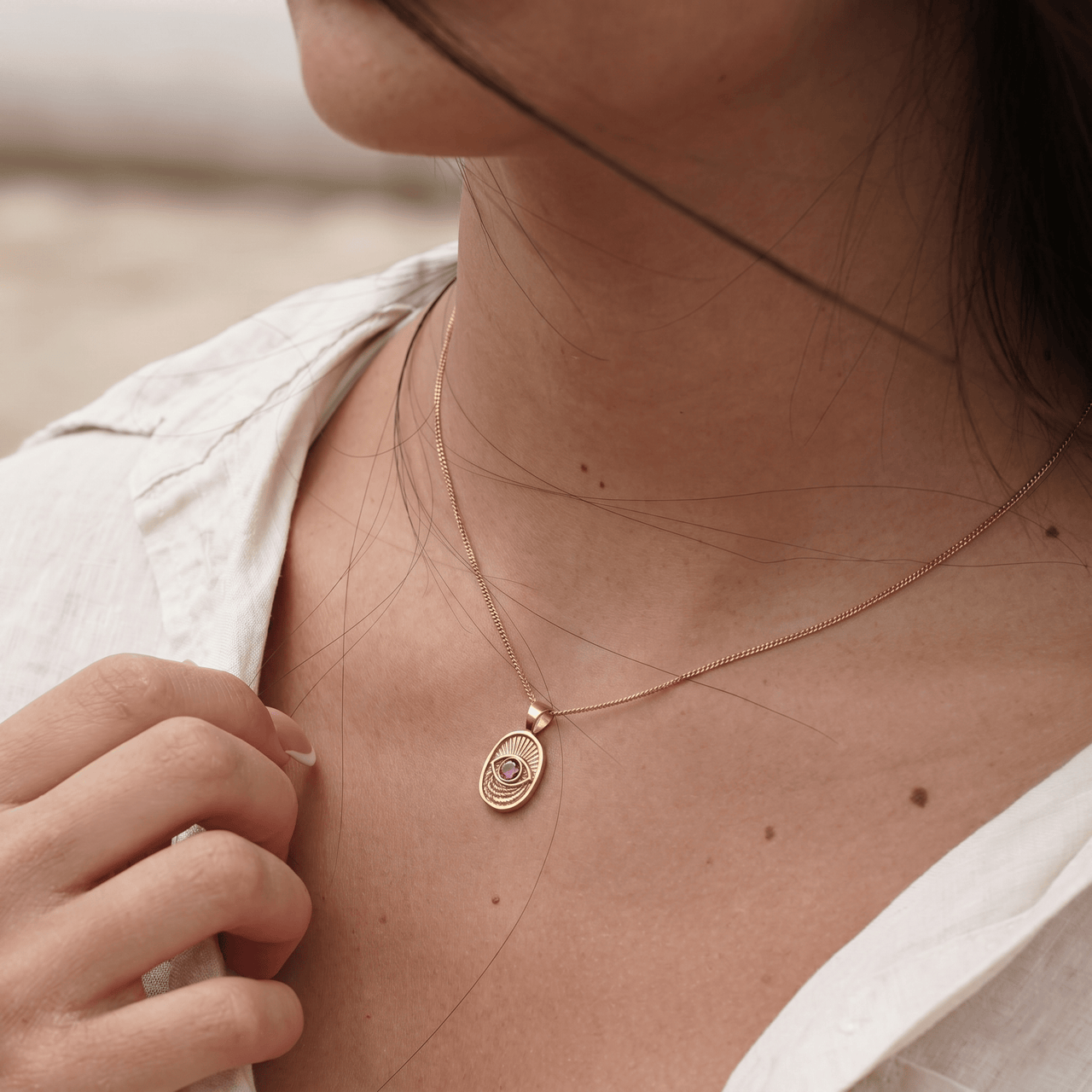 Model wearing the Window to the Soul necklace in 14k gold