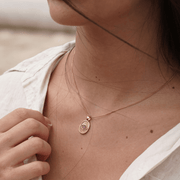 Model wearing the Window to the Soul necklace in 14k gold