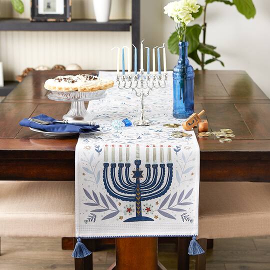 Hannukah/menorah table runner. Menorah/Happy Hannukah written. borders: cream and store gold and outer in blu&silver Star of David 48x14”